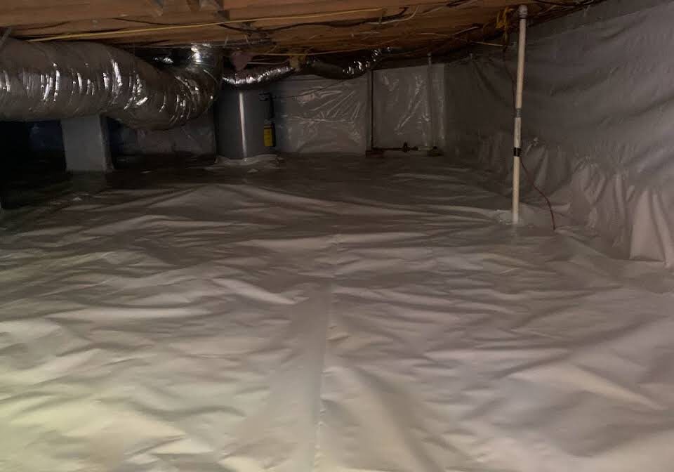 A room that has been covered in white tarps.