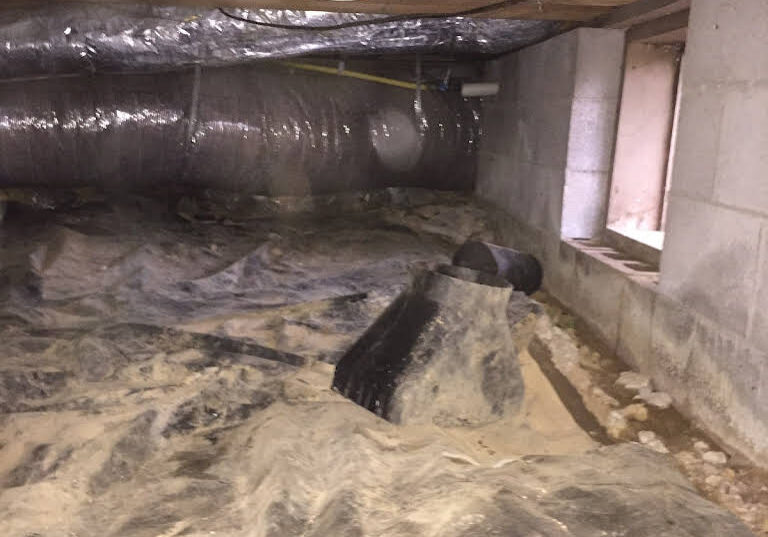 A crawl space with water damage and no roof.